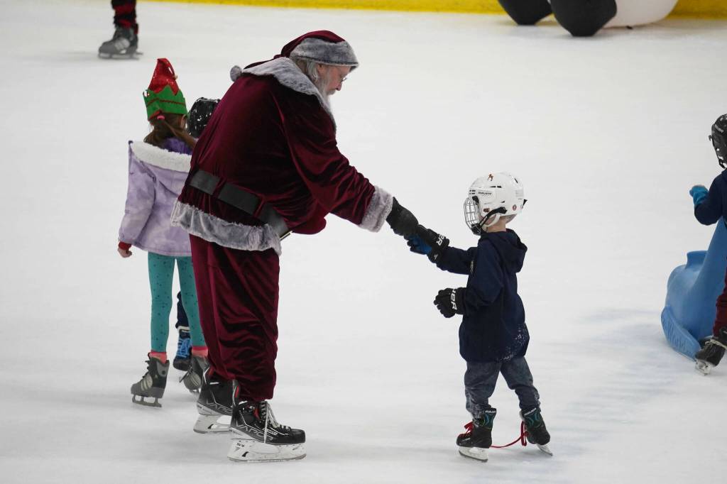 Santa Claus greets children during Skate with Santa at the Soldotna Regional Sports Complex in Soldotna, Alaska, on Saturday, Dec. 21, 2024. (Jake Dye/Peninsula Clarion)