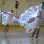 Skaters perform Angels in the Snow during the 23rd Annual Christmas Lights and Holiday Nights Skating Recital at the Soldotna Regional Sports Complex in Soldotna, Alaska, on Saturday, Dec. 21, 2024. (Jake Dye/Peninsula Clarion)