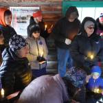 A group of people sing Silent Night in the Elwell Fishing Lodge at the Kenai National Wildlife Refuge near Soldotna, Alaska, on Christmas Eve, Dec. 24, 2024. (Jake Dye/Peninsula Clarion)