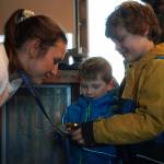 Kristen Faulkner, who won two gold medals for cycling at the Paris 2024 Olympics, speaks to James Elam and his brothers during a meet and greet hosted by the Kenai and Soldotna chambers of commerce at the Cannery Lodge in Kenai, Alaska, on Saturday, Dec. 28, 2024. (Jake Dye/Peninsula Clarion)