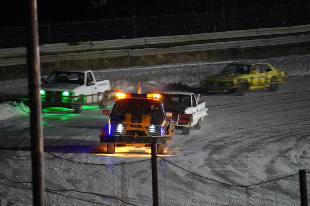Racers vie for the lead in the first race of the Kenai Peninsula Ice Racing season at Twin City Raceway in Kenai, Alaska, on Tuesday, Dec. 31, 2024. (Jake Dye/Peninsula Clarion)