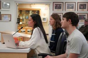 Soldotna High School Student Council President Emma Glassmaker and executive board members Cammy Kincaid and Will Klein speak to the Kenai Peninsula Borough Assembly in Soldotna, Alaska, on Tuesday, Jan. 7, 2025. (Jake Dye/Peninsula Clarion)