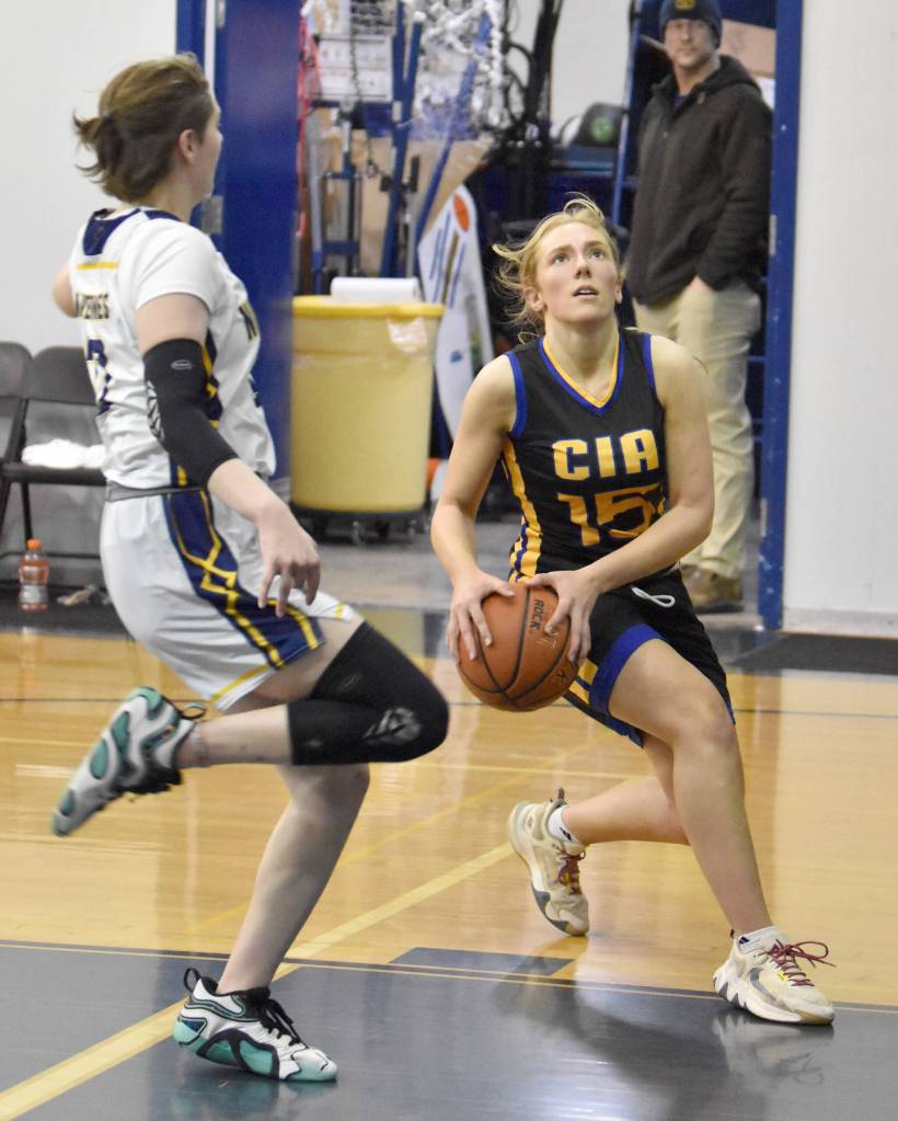 Cook Inlet Academys Clara Warren drives against Ninilchiks Lucy Reynolds on Tuesday, Jan. 7, 2025, at Ninilchik School in Ninilchik, Alaska. (Photo by Jeff Helminiak/Peninsula Clarion)