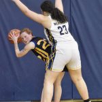 Cook Inlet Academys Beka Dillingham holds off pressure from Ninilchiks Caelis Cress on Tuesday, Jan. 7, 2025, at Ninilchik School in Ninilchik, Alaska. (Photo by Jeff Helminiak/Peninsula Clarion)