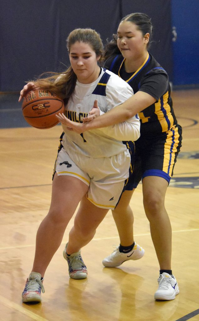 Ninilchiks Lily Berger drives on Cook Inlet Academys Kelsi Curren on Tuesday, Jan. 7, 2025, at Ninilchik School in Ninilchik, Alaska. (Photo by Jeff Helminiak/Peninsula Clarion)
