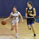 Ninilchiks Kate Hendryx brings the ball up under pressure from Cook Inlet Academys Maddison Curren on Tuesday, Jan. 7, 2025, at Ninilchik School in Ninilchik, Alaska. (Photo by Jeff Helminiak/Peninsula Clarion)