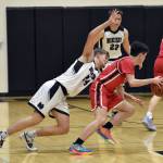 Kenai Centrals Ben Harris protects the ball from Nikiskis Ethan Ellis on Thursday, Jan. 9, 2025, at Nikiski Middle-High School in Nikiski, Alaska. (Photo by Jeff Helminiak/Peninsula Clarion)