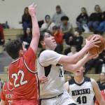 Nikiskis Kevin Love drives on Kenai Centrals Ben Harris on Thursday, Jan. 9, 2025, at Nikiski Middle-High School in Nikiski, Alaska. (Photo by Jeff Helminiak/Peninsula Clarion)