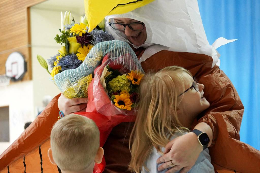 Students embrace Aubrie Ellis after she was named National Outstanding Assistant Principal of 2025 by the Alaska Association of Elementary School Principals at Mountain View Elementary School in Kenai, Alaska, on Friday, Jan. 10, 2025. (Jake Dye/Peninsula Clarion)