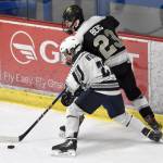 Soldotna's Paul Wertanen and South's Devin Berg battle for the puck Friday, Jan. 10, 2025, at the Soldotna Regional Sports Complex in Soldotna, Alaska. (Photo by Jeff Helminiak/Peninsula Clarion)
