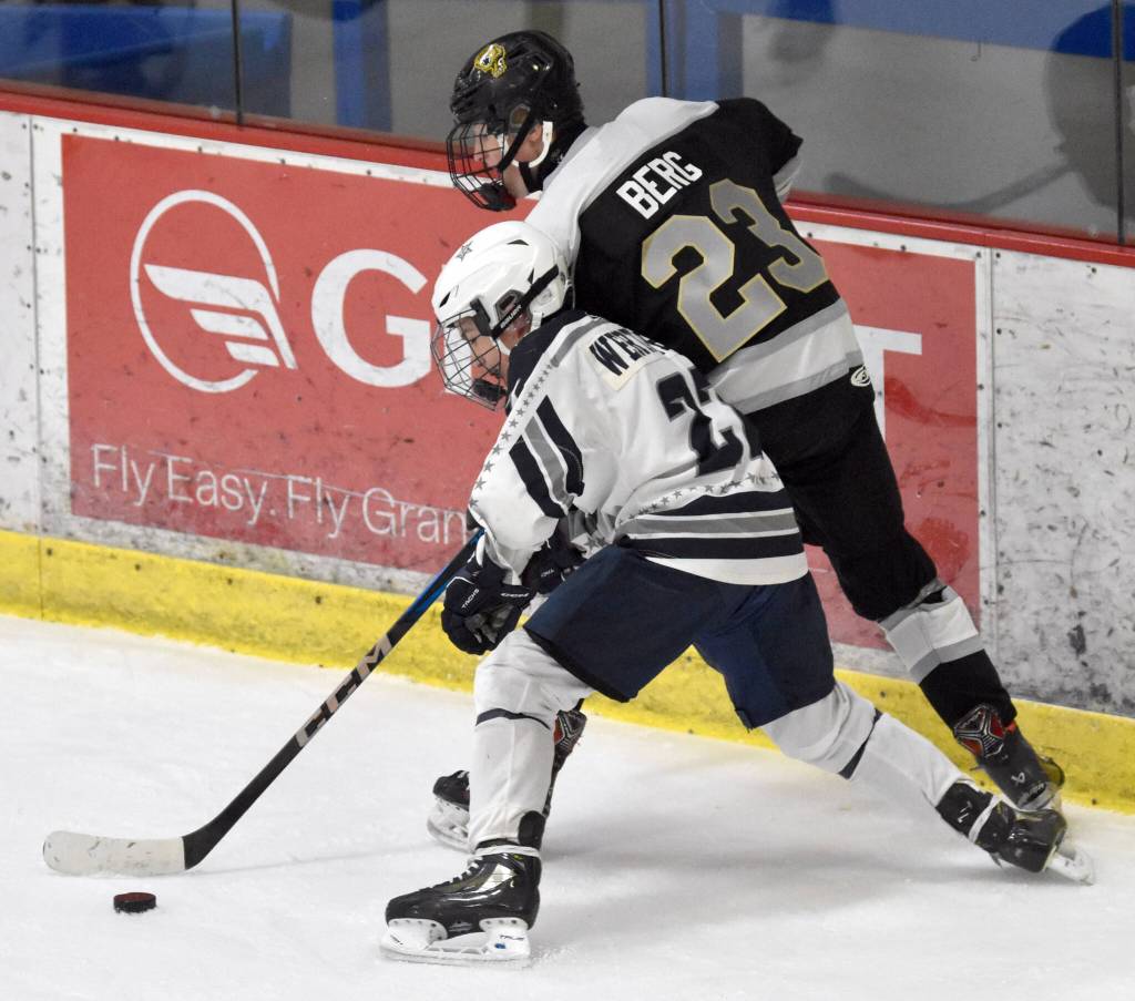 Soldotna's Paul Wertanen and South's Devin Berg battle for the puck Friday, Jan. 10, 2025, at the Soldotna Regional Sports Complex in Soldotna, Alaska. (Photo by Jeff Helminiak/Peninsula Clarion)