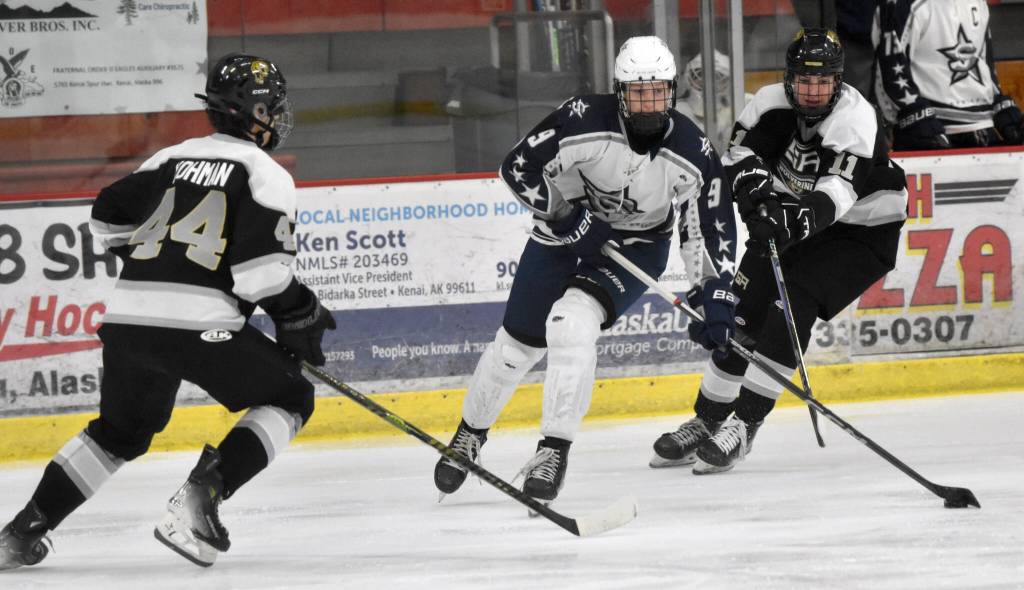 Soldotnas Peyton Williams splits Souths Nick Yohman and Alex Green on Friday, Jan. 10, 2025, at the Soldotna Regional Sports Complex in Soldotna, Alaska. (Photo by Jeff Helminiak/Peninsula Clarion)