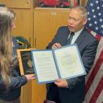 Seward Deputy Fire Chief Katherine McCoy is presented the 2024 Ken Akerley Fire Service Leadership Award by State Fire Marshal Lloyd Nakano at Seward Fire Department in Seward, Alaska. (Photo provided by Seward Fire Chief Clinton Crites)
