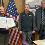Seward Deputy Fire Chief Katherine McCoy stands for a photo with Seward Fire Chief Clinton Crites and Assistant State Fire Marshal Mark Brauneis after McCoy was presented the 2024 Ken Akerley Fire Service Leadership Award at Seward Fire Department in Seward, Alaska. (Photo provided by Seward Fire Chief Clinton Crites)