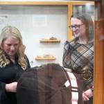 Kenai Chamber of Commerce Finance and Operations Coordinator Natalie Garrett and Kenai Cultural Center Coordinator Danielle Lopez Stamm view traditional attire during the grand reopening of the cultural center at the Kenai Chamber of Commerce and Visitor Center in Kenai, Alaska, on Wednesday, Jan. 15, 2025. (Jake Dye/Peninsula Clarion)