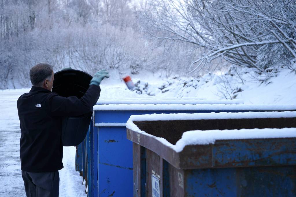 Kenai Peninsula Borough Mayor Peter Micciche dumps aluminum cans into recycling containers at the Central Peninsula Landfill in Soldotna, Alaska, on Thursday, Jan. 16, 2025. (Jake Dye/Peninsula Clarion)