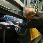 Kenai Peninsula Borough Mayor Peter Micciche points to where the baler ram severed from the machine at the Central Peninsula Landfill in Soldotna, Alaska, on Thursday, Jan. 16, 2025. (Jake Dye/Peninsula Clarion)