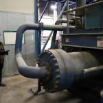 Kenai Peninsula Borough Mayor Peter Micciche points to where the disconnected baler ram has bent piping at the Central Peninsula Landfill in Soldotna, Alaska, on Thursday, Jan. 16, 2025. (Jake Dye/Peninsula Clarion)