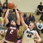 Dimonds Jace Christophersen drives on Nikiskis Kameron Bird at the 36th Annual Rus Hitchcock Nikiski Tip Off Tournament on Thursday, Jan. 16, 2025, at Nikiski Middle-High School in Nikiski, Alaska. (Photo by Jeff Helminiak/Peninsula Clarion)