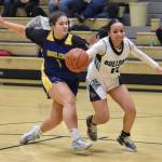 Nikiskis Madison Iyatunguk is fouled by Ninilchiks Lily Berger at the 36th Annual Rus Hitchcock Nikiski Tip Off Tournament on Thursday, Jan. 16, 2025, at Nikiski Middle-High School in Nikiski, Alaska. (Photo by Jeff Helminiak/Peninsula Clarion)