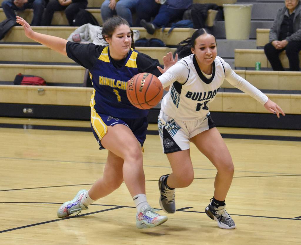 Nikiskis Madison Iyatunguk is fouled by Ninilchiks Lily Berger at the 36th Annual Rus Hitchcock Nikiski Tip Off Tournament on Thursday, Jan. 16, 2025, at Nikiski Middle-High School in Nikiski, Alaska. (Photo by Jeff Helminiak/Peninsula Clarion)