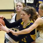 Ninilchik's Lucy Reynolds grabs the ball in front of Nikiski's Blakeley Jorgensen and Abby White at the 36th Annual Rus Hitchcock Nikiski Tip Off Tournament on Thursday, Jan. 16, 2025, at Nikiski Middle-High School in Nikiski, Alaska. (Photo by Jeff Helminiak/Peninsula Clarion)