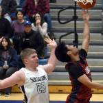 Jaidhen Oyao of Mountain City Christian Academy drives against Theo Huff of Soldotna on Friday, Jan. 17, 2025, at Soldotna High School in Soldotna, Alaska. (Photo by Jeff Helminiak/Peninsula Clarion)