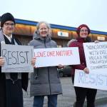 Diane Peterson, Casady Herding and Jen Brighton stand with signs sharing Martin Luther King Jr. quotes are calling to "Resist" along the side of the Kenai Spur Highway in Soldotna, Alaska, on Monday, Jan. 20, 2025. (Jake Dye/Peninsula Clarion)