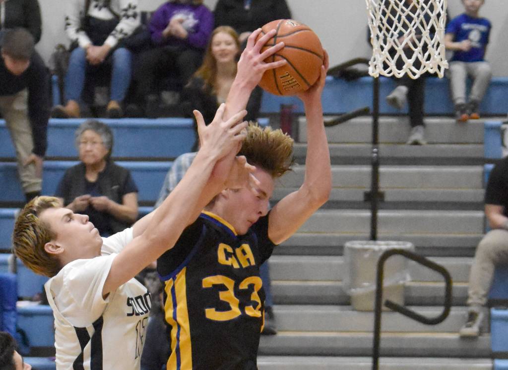 Soldotnas Scott Bieber and Cook Inlet Academys Brandt Rollman battle for the rebound at the Revolution Sport and Spine Therapy Al Howard Shootout on Thursday, January 23, 2025, at Soldotna High School in Soldotna, Alaska. (Photo by Jeff Helminiak/Peninsula Clarion)