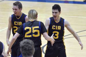 Owen Braband, Hyrum Henderson and Ian McGarry of Cook Inlet Academy celebrate a victory over Soldotna at the Revolution Sport and Spine Therapy Al Howard Shootout on Thursday, January 23, 2025, at Soldotna High School in Soldotna, Alaska. (Photo by Jeff Helminiak/Peninsula Clarion)