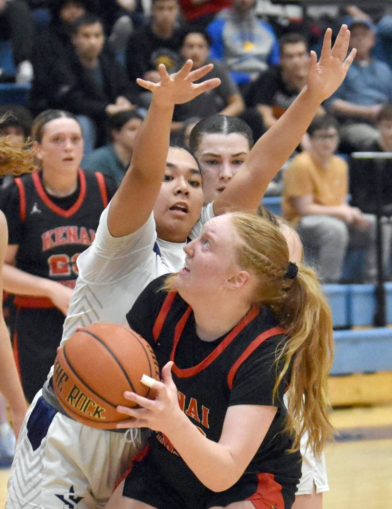Kenai Centrals Ellsi Miller tries to shoot over Isabelle Cruz of Soldotna on Friday, Jan. 24, 2025, at the Revolution Sport and Spine Therapy Al Howard Shootout at Soldotna High School in Soldotna, Alaska. (Photo by Jeff Helminiak/Peninsula Clarion)