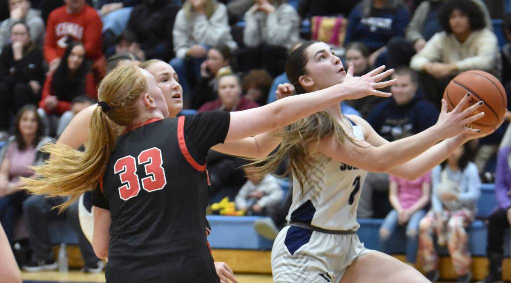 Soldotnas Anaulie Sedivy drives past Kenai Centrals Ellsi Miller and Gracee Every on Friday, Jan. 24, 2025, at the Revolution Sport and Spine Therapy Al Howard Shootout at Soldotna High School in Soldotna, Alaska. (Photo by Jeff Helminiak/Peninsula Clarion)