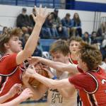 Soldotnas Jayden Stuyvesant drives on Kenai Centrals Mason Tunseth and Caleb Litke on Friday, Jan. 24, 2025, at the Revolution Sport and Spine Therapy Al Howard Shootout at Soldotna High School in Soldotna, Alaska. (Photo by Jeff Helminiak/Peninsula Clarion)