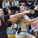 Soldotna's Anaulie Sedivy drives past Kenai Central's Ellsi Miller and Gracee Every on Friday, Jan. 24, 2025, at the Revolution Sport and Spine Therapy Al Howard Shootout at Soldotna High School in Soldotna, Alaska. (Photo by Jeff Helminiak/Peninsula Clarion)