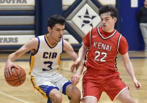 Cook Inlet Academy's Ian McGarry dribbles against Kenai Central's Ben Harris on Saturday, Jan. 25, 2025, at the Revolution Sport and Spine Therapy Al Howard Shootout at Soldotna High School in Soldotna, Alaska. (Photo by Jeff Helminiak/Peninsula Clarion)