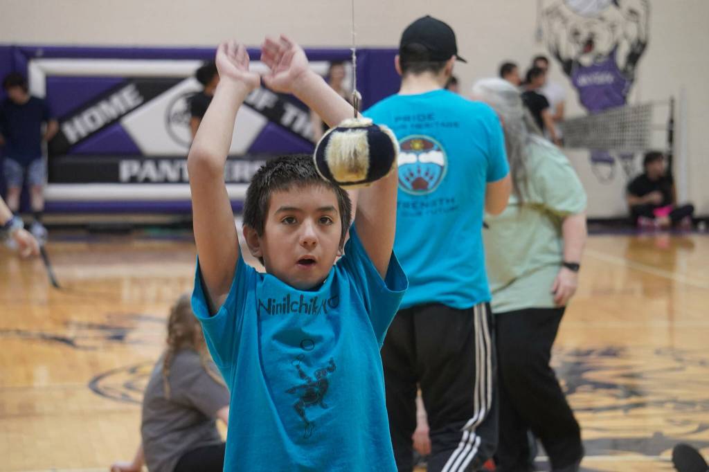 An athlete prepares to attempt the one-foot high kick during the Kahtnuhtana Hey Chiula Native Youth Olympics Invitational at Skyview Middle School near Soldotna, Alaska, on Sunday, Jan. 26, 2025. (Jake Dye/Peninsula Clarion)