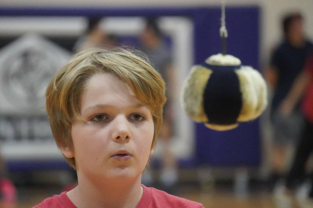 An athlete prepares to attempt the one-foot high kick during the Kahtnuhtana Hey Chiula Native Youth Olympics Invitational at Skyview Middle School near Soldotna, Alaska, on Sunday, Jan. 26, 2025. (Jake Dye/Peninsula Clarion)