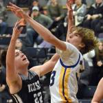 Nikiskis Ryder Maguire and Brandy Rollman of Cook Inlet Academy battle for the ball Tuesday, Jan. 28, 2025, at Cook Inlet Academy just outside of Soldotna, Alaska. (Photo by Jeff Helminiak/Peninsula Clarion)