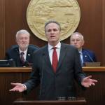 Gov. Mike Dunleavy delivers his State of the State speech at the Alaska State Capitol on Tuesday, Jan. 28, 2025, with Senate President Gary Stevens, at left, and House Speaker Bryce Edgmon, at right, in the background. (Klas Stolpe/Juneau Empire)