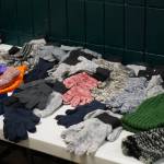 An array of hats and gloves are available to participants of the 14th Annual Project Homeless Connect at the Soldotna Regional Sports Complex in Soldotna, Alaska, on Tuesday, Jan. 28, 2025. (Jake Dye/Peninsula Clarion)