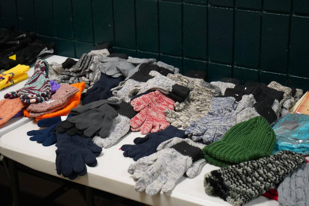 An array of hats and gloves are available to participants of the 14th Annual Project Homeless Connect at the Soldotna Regional Sports Complex in Soldotna, Alaska, on Tuesday, Jan. 28, 2025. (Jake Dye/Peninsula Clarion)