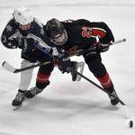 Soldotnas Draiden Mullican and Kenai Centrals Noah Hallam battle for the puck Thursday, Jan. 30, 2025, at the Soldotna Regional Sports Complex in Soldotna, Alaska. (Photo by Jeff Helminiak/Peninsula Clarion)