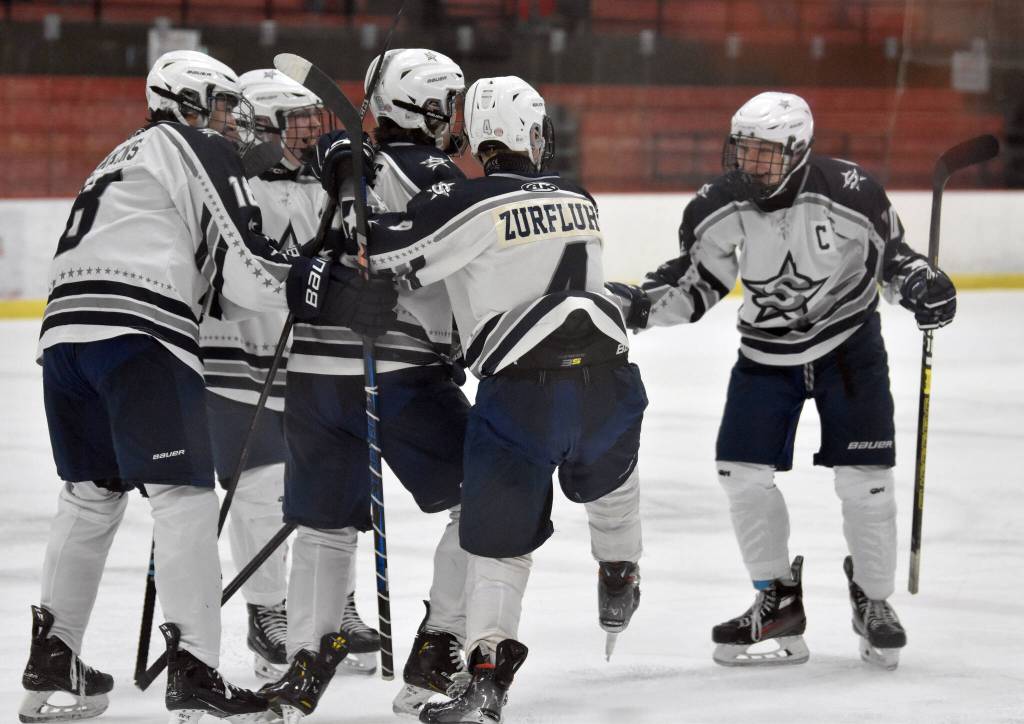 Soldotna celebrates a goal from Daniel Heath (far right) on Thursday, Jan. 30, 2025, at the Soldotna Regional Sports Complex in Soldotna, Alaska. (Photo by Jeff Helminiak/Peninsula Clarion)
