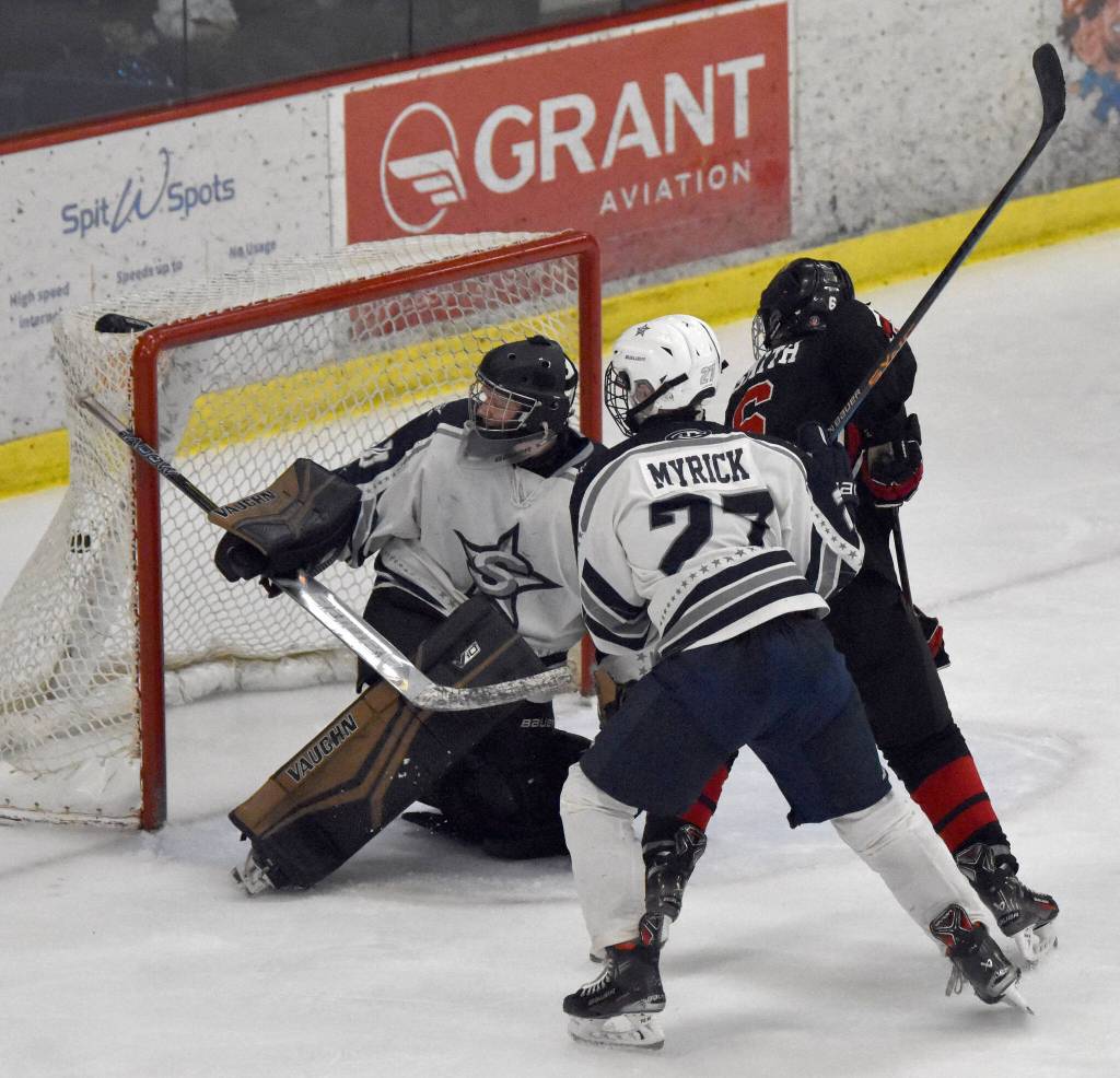 Kenai Centrals Braden Smith gets past defenseman Keegan Myrick and goalie Brycen Clyde to tie the game in the third period Thursday, Jan. 30, 2025, at the Soldotna Regional Sports Complex in Soldotna, Alaska. (Photo by Jeff Helminiak/Peninsula Clarion)