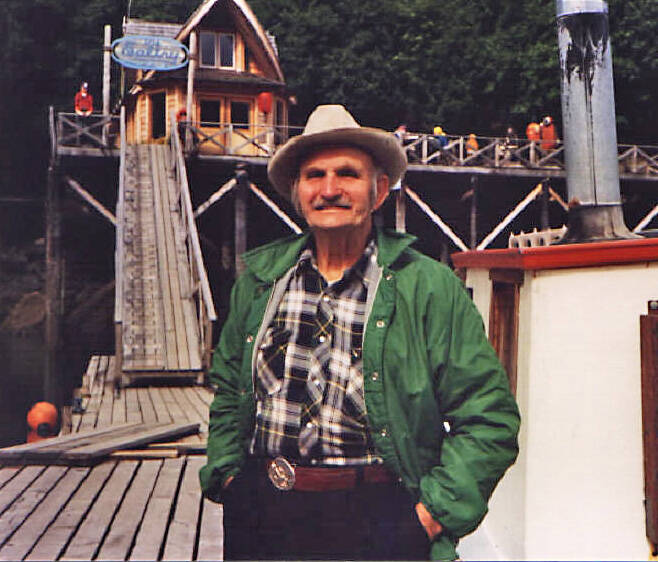 In the 1990s, Poopdeck Platt enjoys some sunshine in front of The Saltry, in Halibut Cove. (Photo courtesy of Ken Moore)