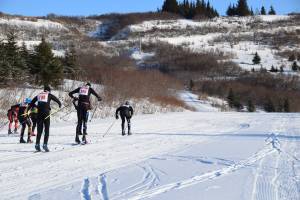 The varsity boys take off from the starting area at the Lookout Mountain Cross-Country Ski Trails on Thursday, Jan. 30. (Chloe Pleznac/Homer News)
