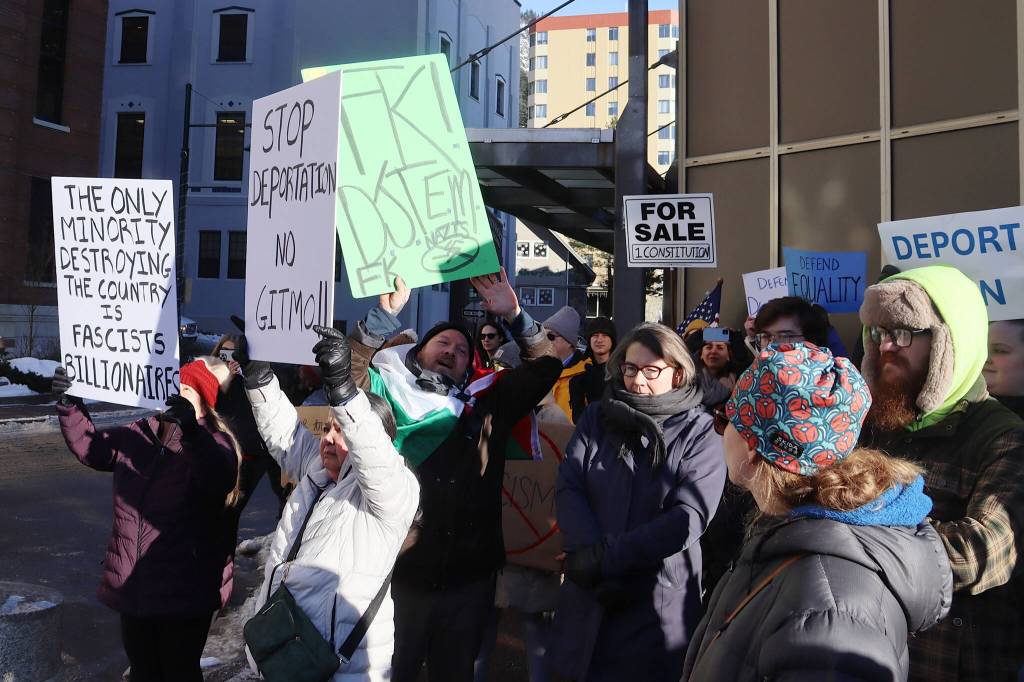 Protesters with signs gather across the street from the Alaska State Capitol on Wednesday during a rally focused on President Donald Trumps actions since the beginning of his second term. (Mark Sabbatini / Juneau Empire)
