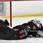 Kenai Centrals Evyn Witt makes a save in front of teammate Gavin Liles against North Pole at the First National Cup Division II state hockey tournament at the Soldotna Regional Sports Complex in Soldotna, Alaska, on Thursday, February 6, 2025. (Photo by Jeff Helminiak/Peninsula Clarion)