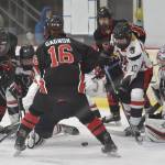 Kenai Centrals Gavin Liles and Ryder Gagnon try to solve Kieran Olson at the First National Cup Division II state hockey tournament at the Soldotna Regional Sports Complex in Soldotna, Alaska, on Thursday, February 6, 2025. (Photo by Jeff Helminiak/Peninsula Clarion)