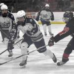 Soldotnas Marshall DeRaeve carries the puck against Kenai Centrals Cole Langham on Friday, Feb. 7, 2025, at the First National Cup Division II state hockey tournament at the Soldotna Regional Sports Complex in Soldotna, Alaska. (Photo by Jeff Helminiak/Peninsula Clarion)